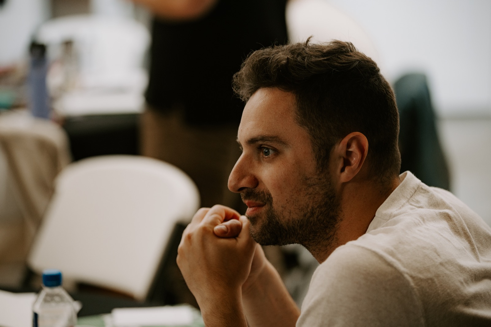 A participant listening thoughtfully at an event