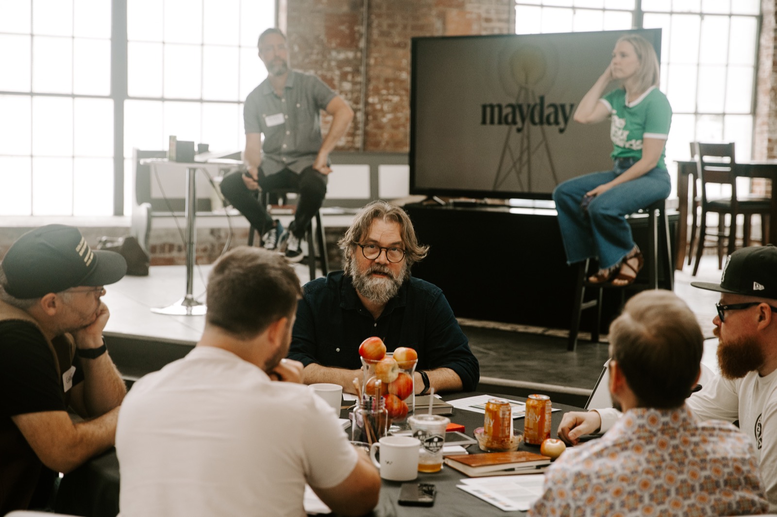 Small groups in conversation at a Mayday event